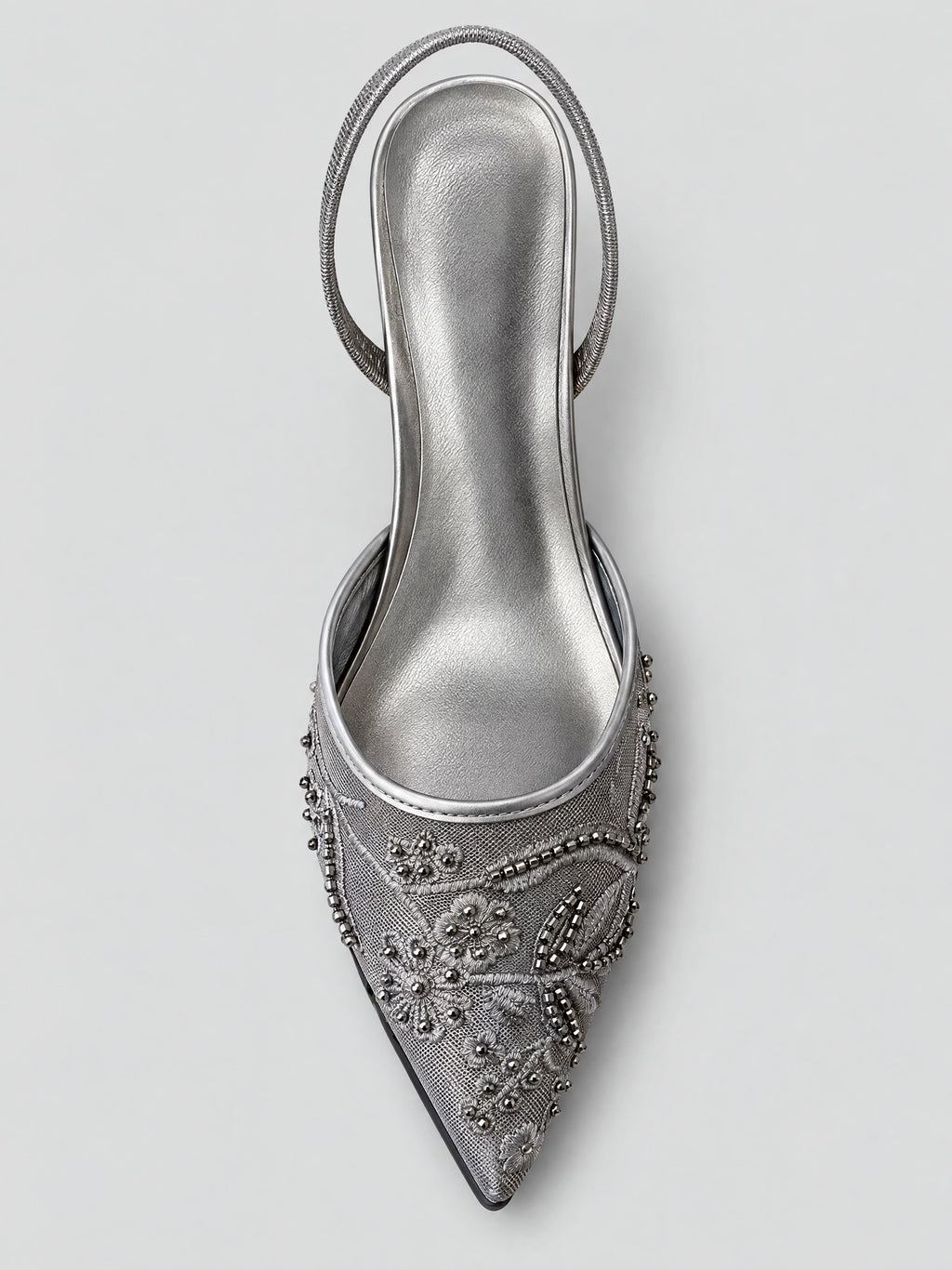Top-down view of a Black slingback high heel with a pointed toe, embroidered floral mesh, bead accents, and back strap.