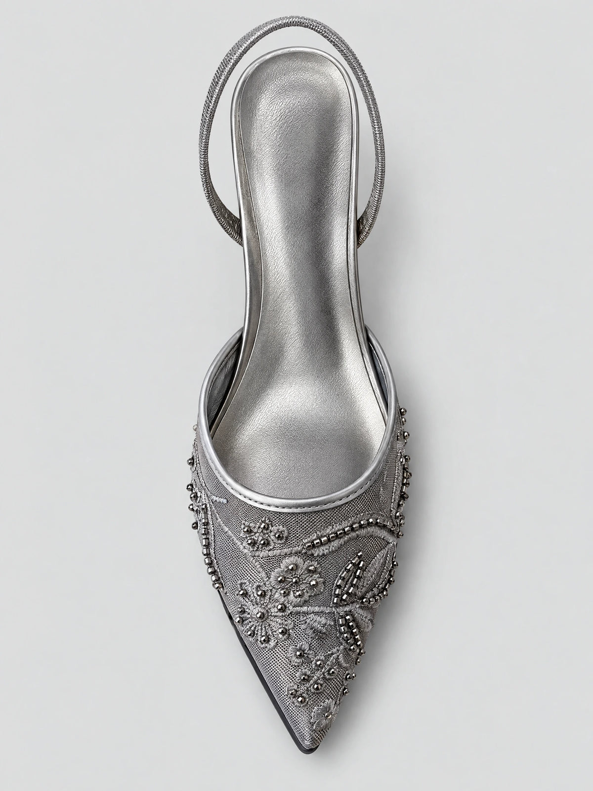Top-down view of a Black slingback high heel with a pointed toe, embroidered floral mesh, bead accents, and back strap.