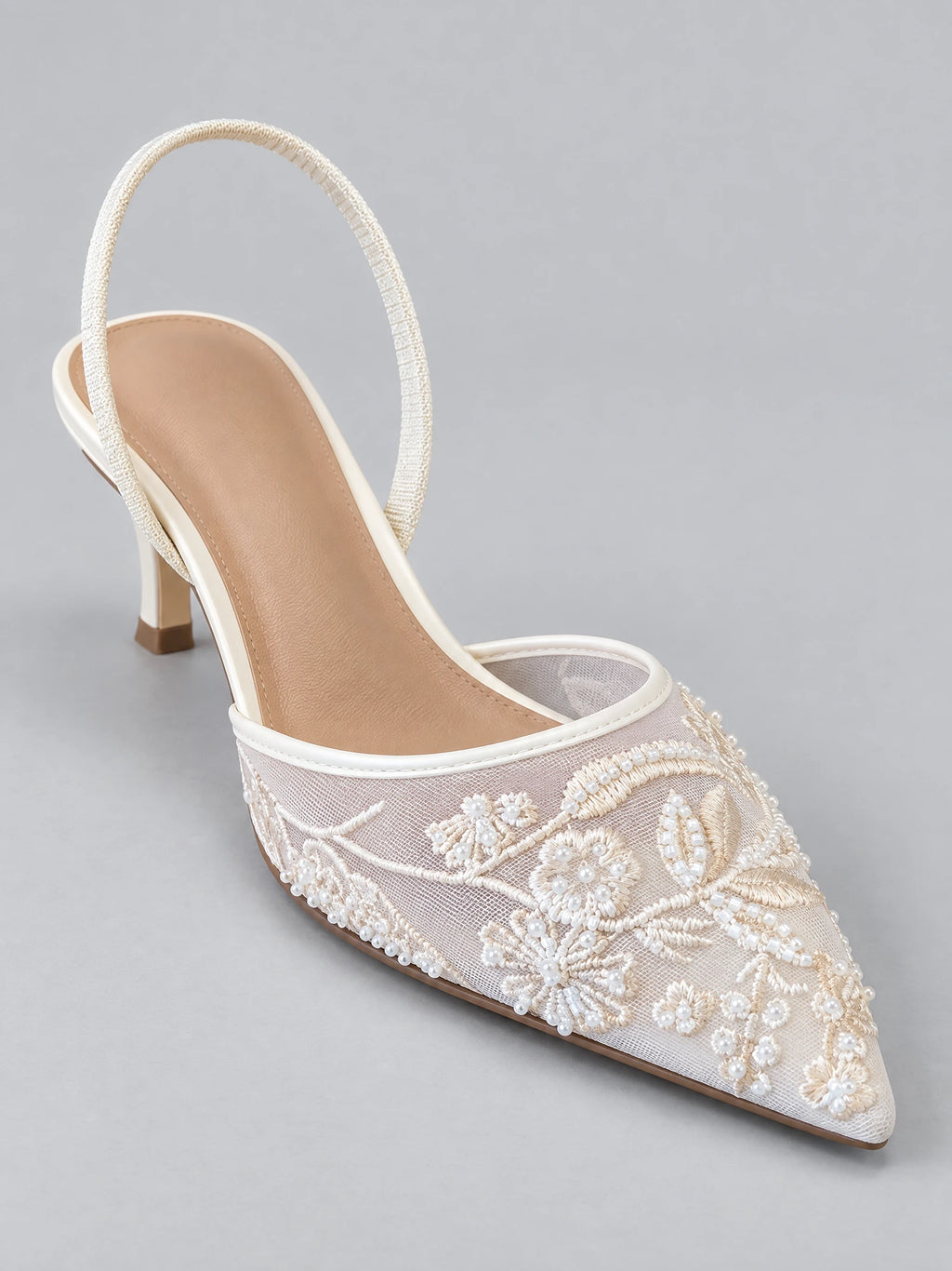 White Back Strap Slingback High Heel shown in three-quarter view with a sheer embroidered floral upper, beaded details, pointed toe, and block heel.