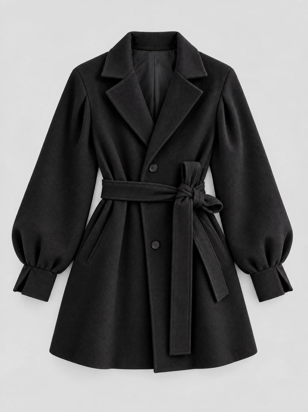 Black belted wool coat laid flat, featuring lantern sleeves, notched lapels, button front, and a tied waist belt.