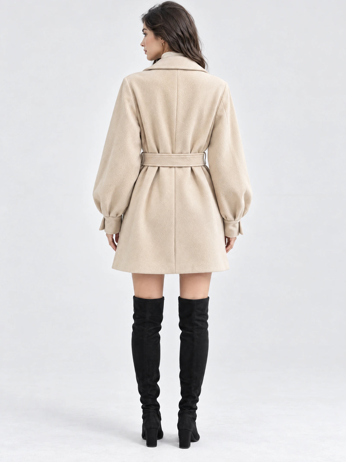 Back view of a model wearing a Beige belted lantern sleeve wool coat with a wide collar and gathered cuffs.