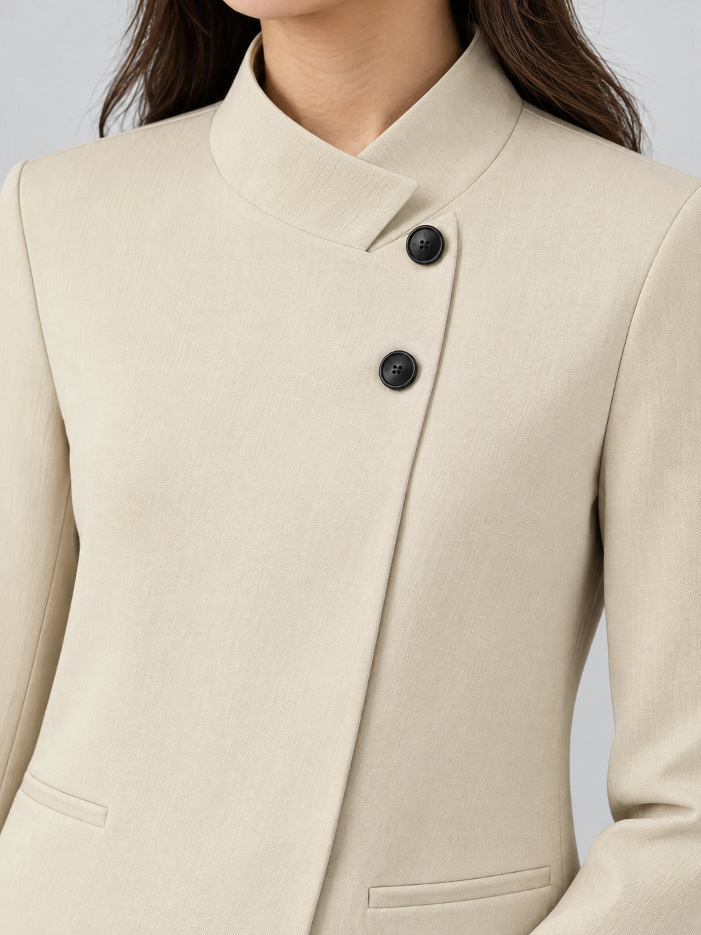 Close-up of a Beige Blazer Blouse showing the notched collar, dark buttons, and welt pockets.
