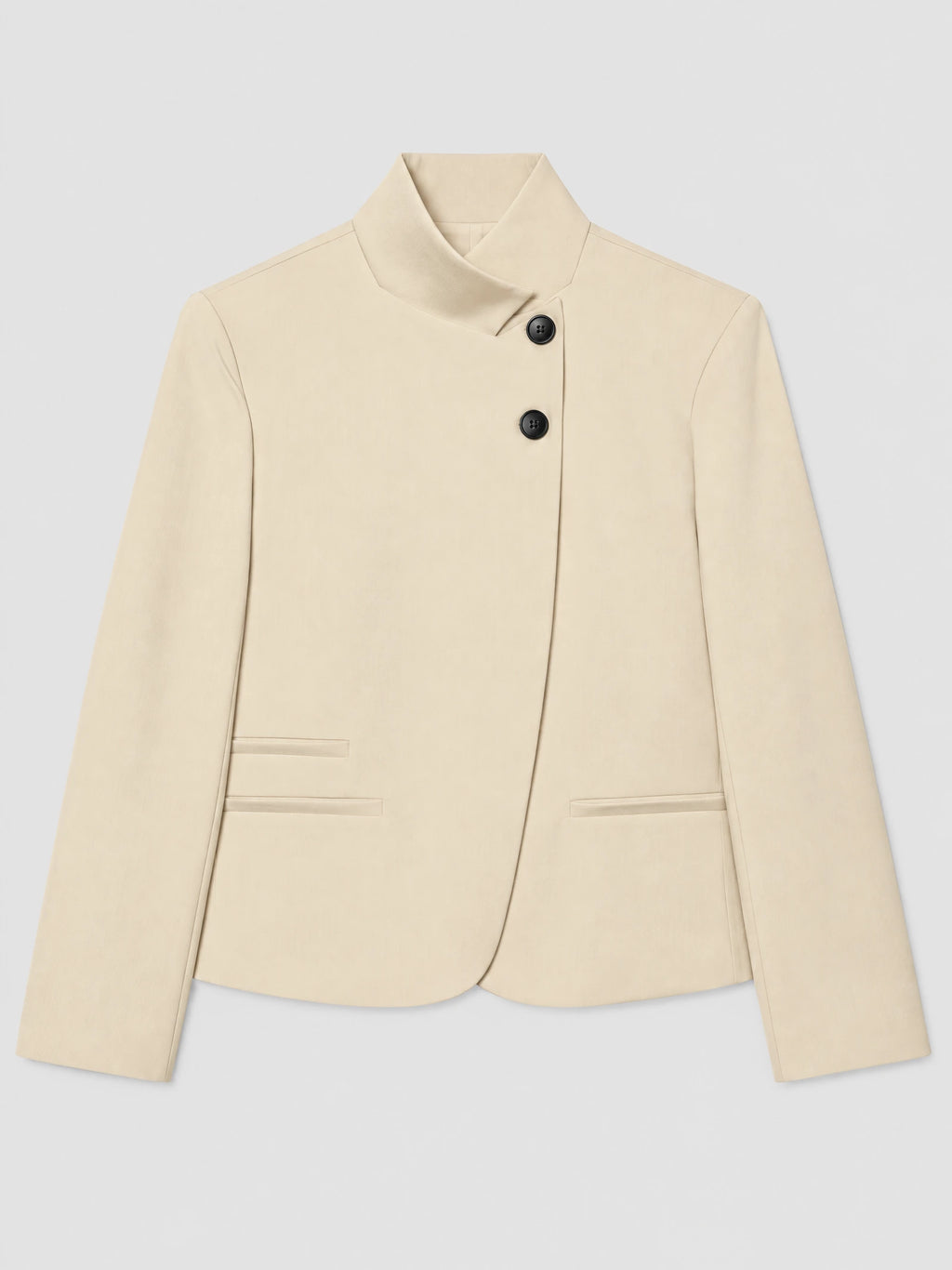 Beige Blazer Blouse laid flat, featuring an asymmetric folded collar, two-button closure, long sleeves, and welt pockets.