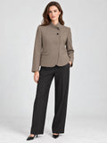 Front studio view of a model wearing a Brown Blazer Blouse with an asymmetric high neckline, two-button closure, and welt pockets.