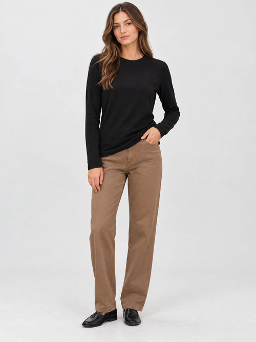 Front studio view of a model wearing a Black cotton long sleeve T-shirt with a crew neckline.