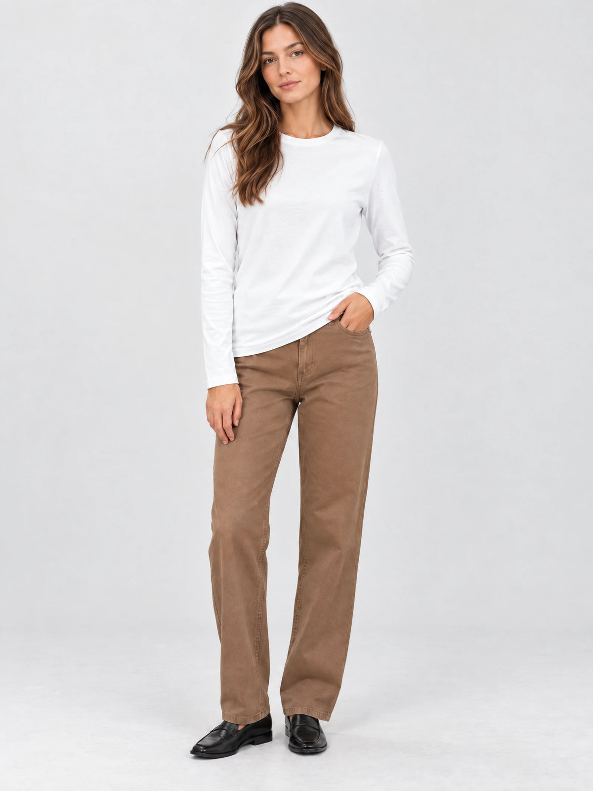 Model wearing a White cotton long sleeve T-shirt with a crew neckline in a front studio view.