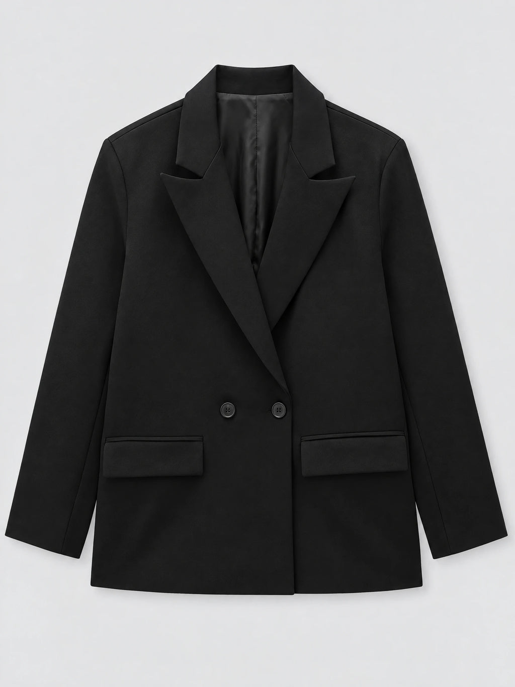 Black double breasted blazer laid flat, featuring notched lapels, two front buttons, and flap pockets.