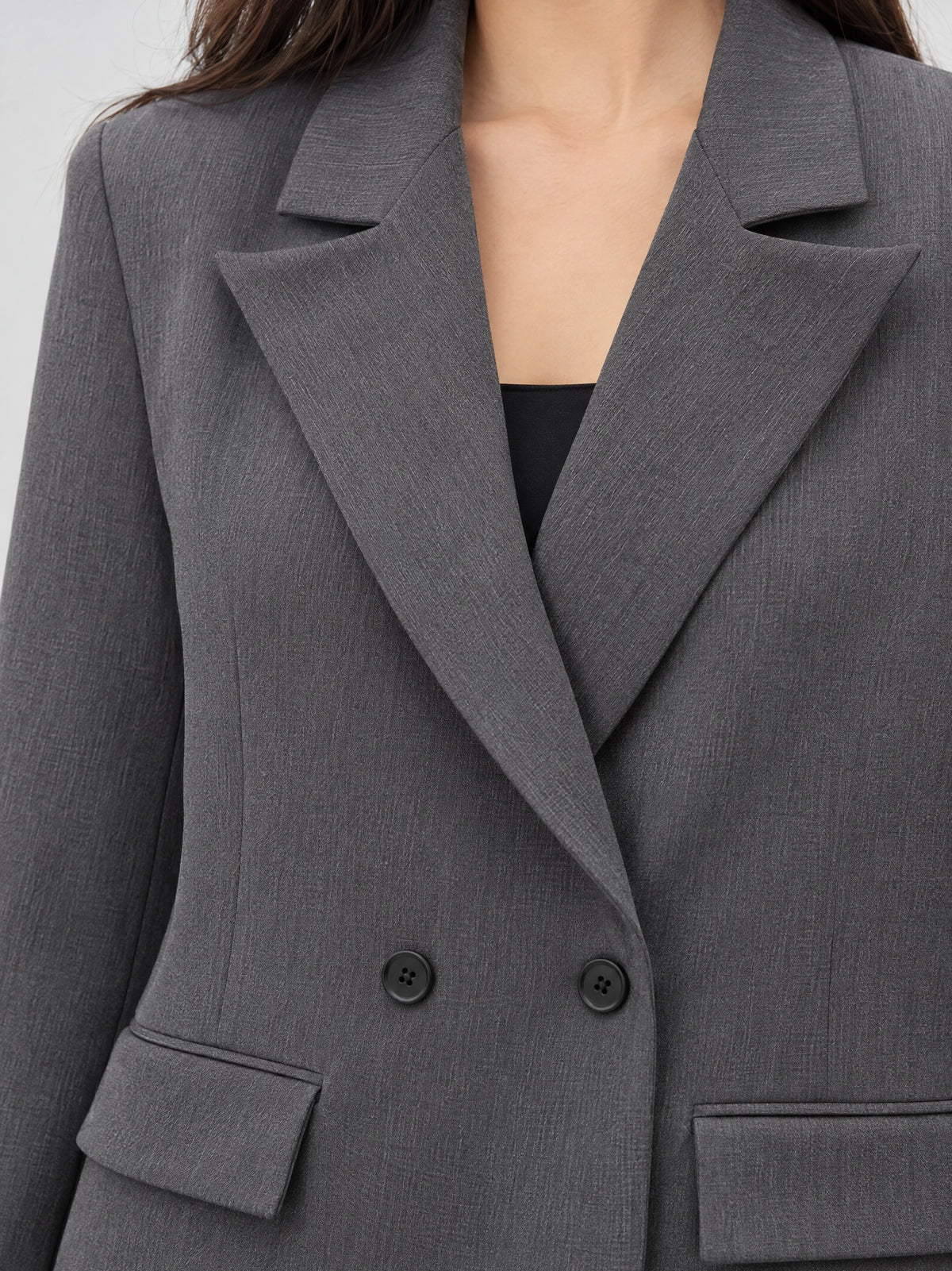 Close-up of the Gray Double Breasted Blazer showing notched lapels, textured fabric, and front buttons.