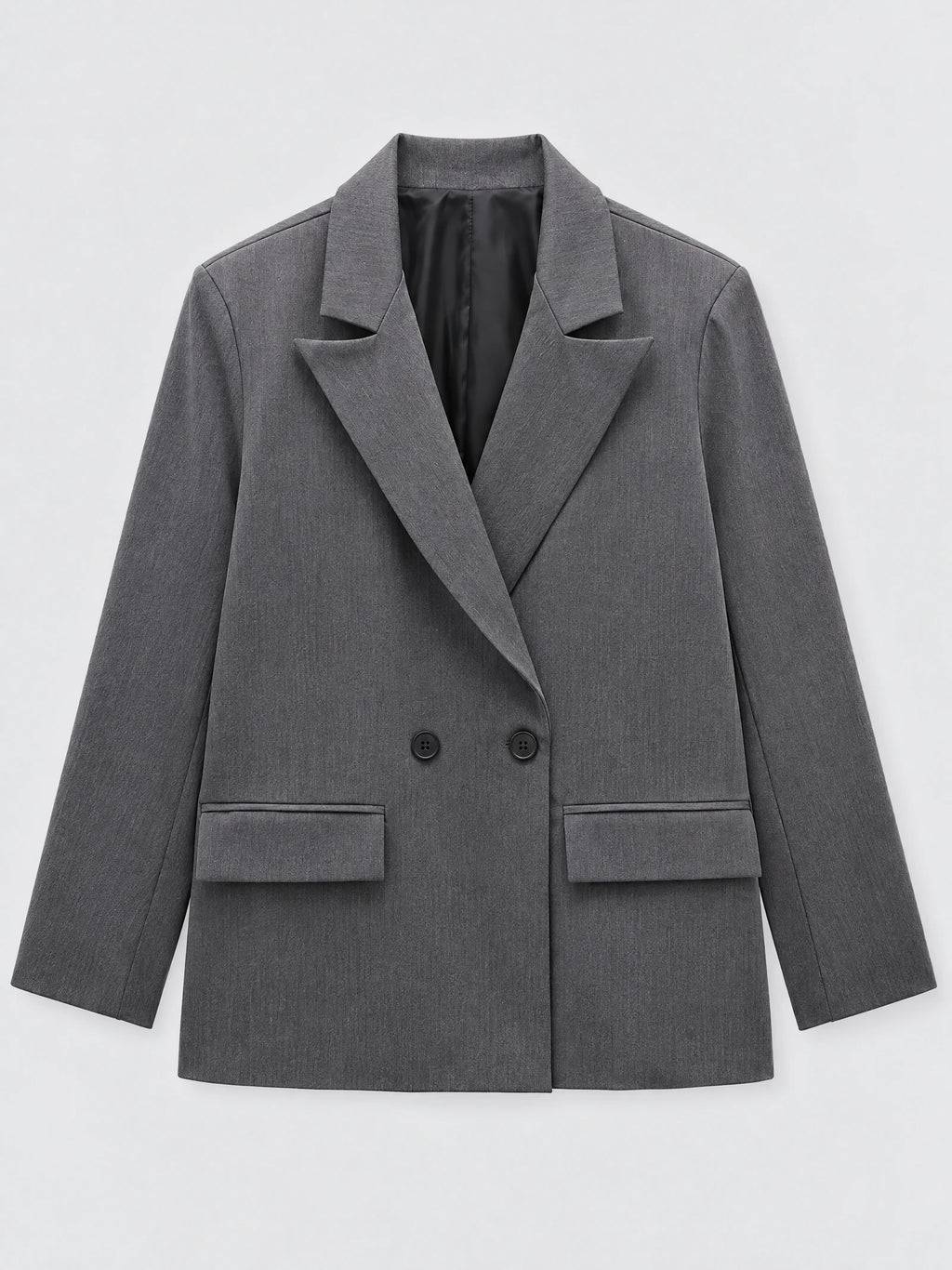 Gray double breasted blazer laid flat, featuring notched lapels, front buttons, and flap pockets.