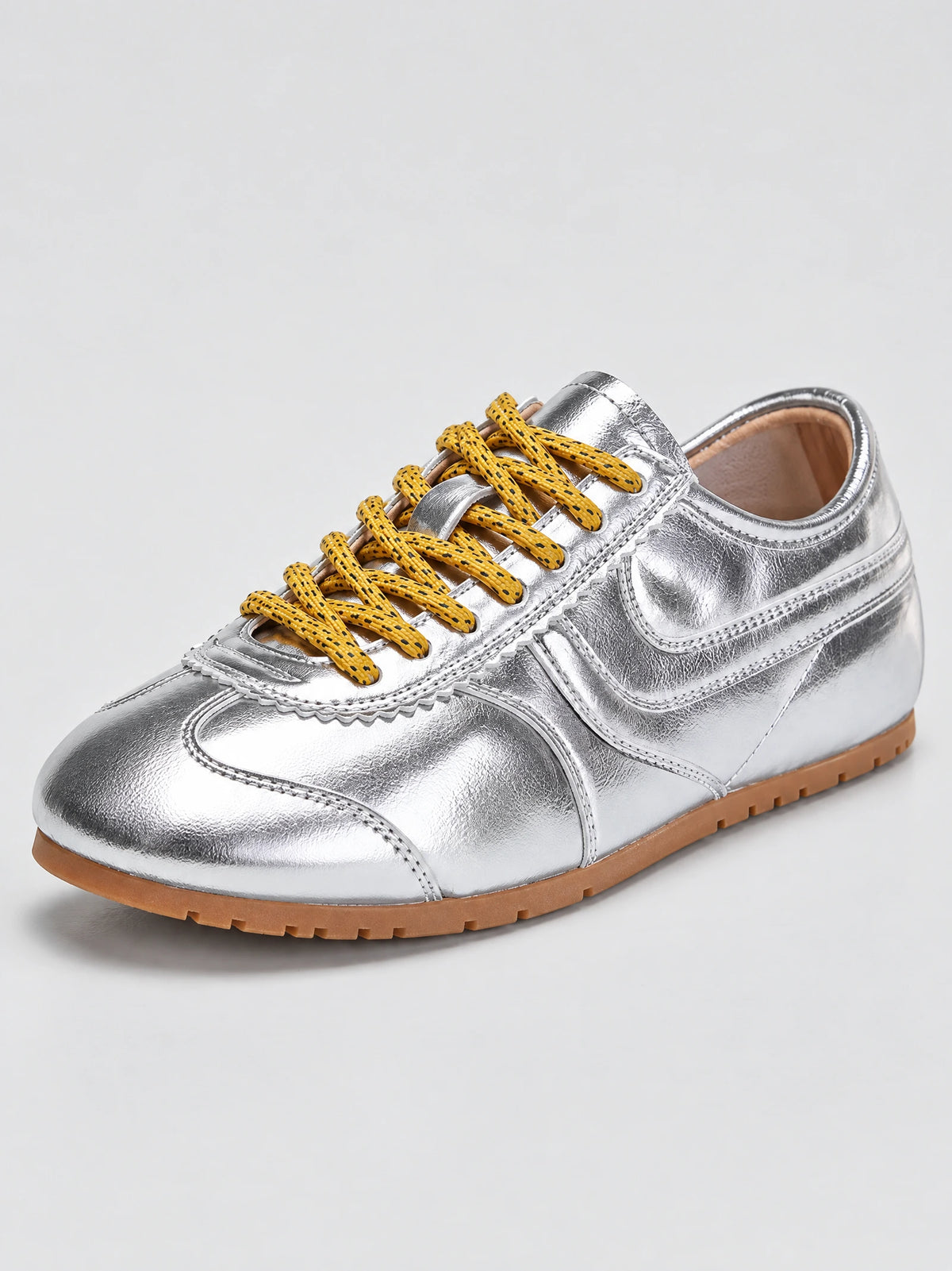 Three-quarter view of Gray leather Gats Shoes sneakers with patterned laces, stitched overlays, and a textured rubber sole.