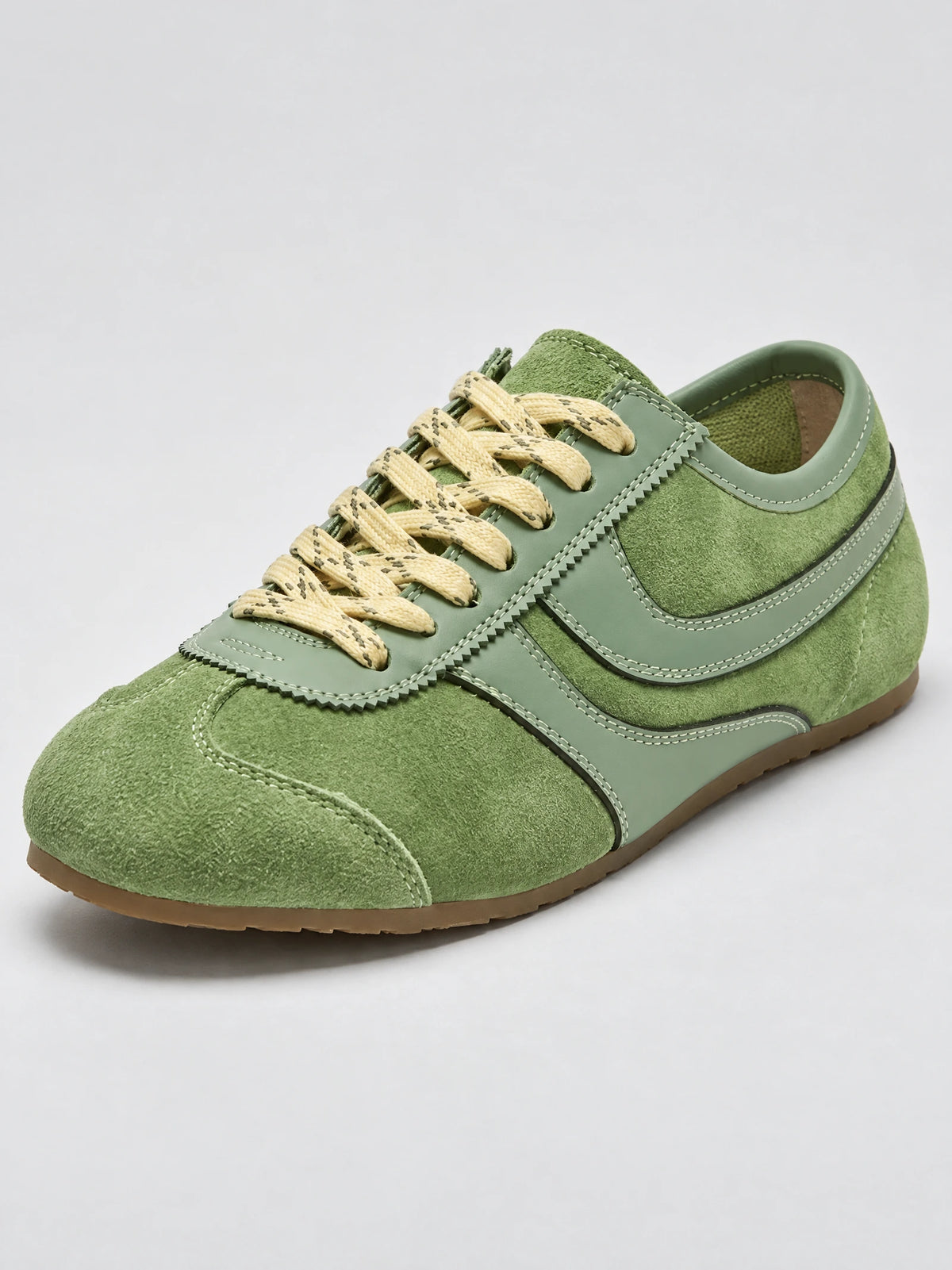 Three-quarter view of Green Gats Shoes leather sneakers with textured suede panels, stitched overlays, and lace-up closure.