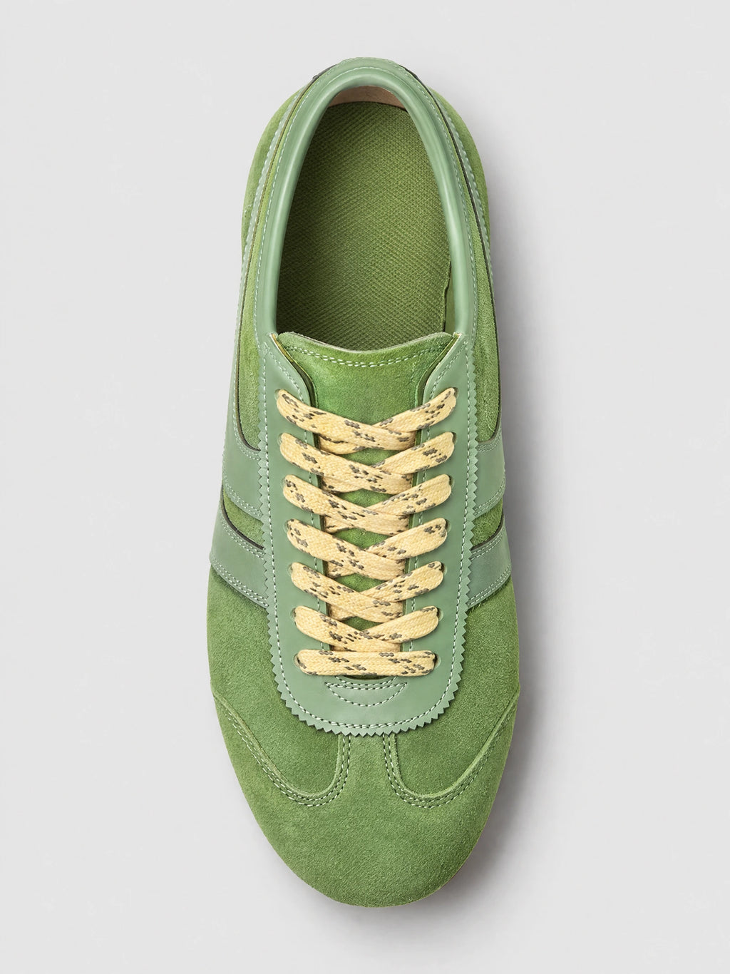Top-down close-up of a Green Gats Shoes leather sneaker with textured upper, stitched panels, and lace-up closure.