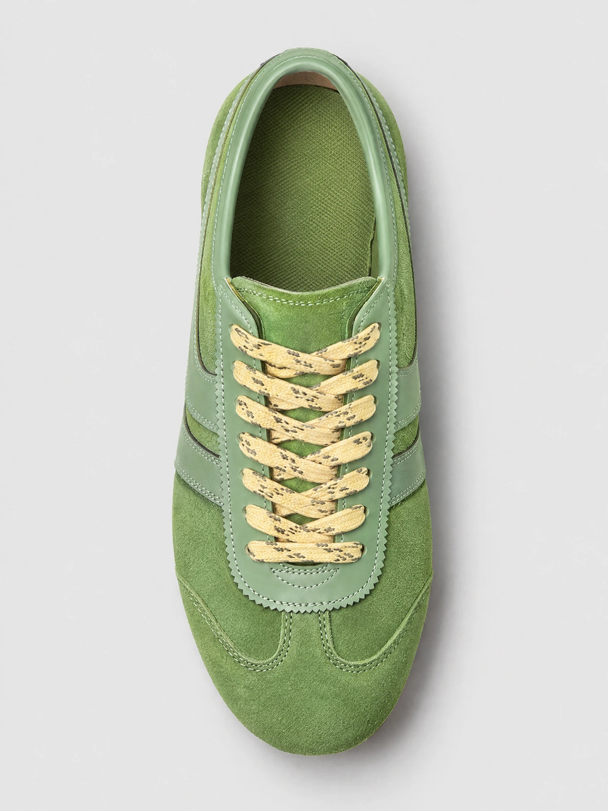 Top-down close-up of a Green Gats Shoes leather sneaker with textured upper, stitched panels, and lace-up closure.