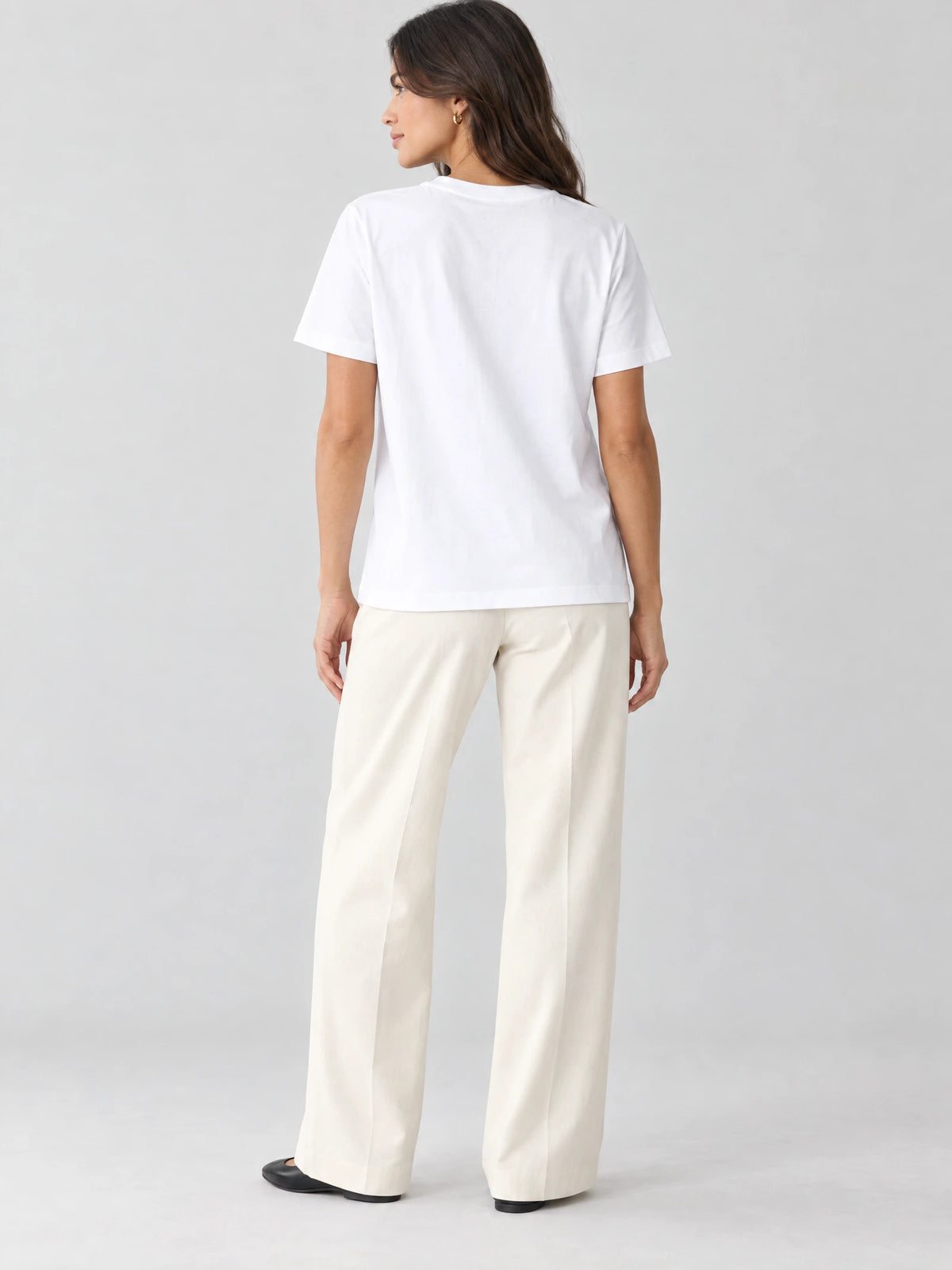 Rear studio view of a model wearing a White heavyweight cotton T-shirt with short sleeves and a straight hem.