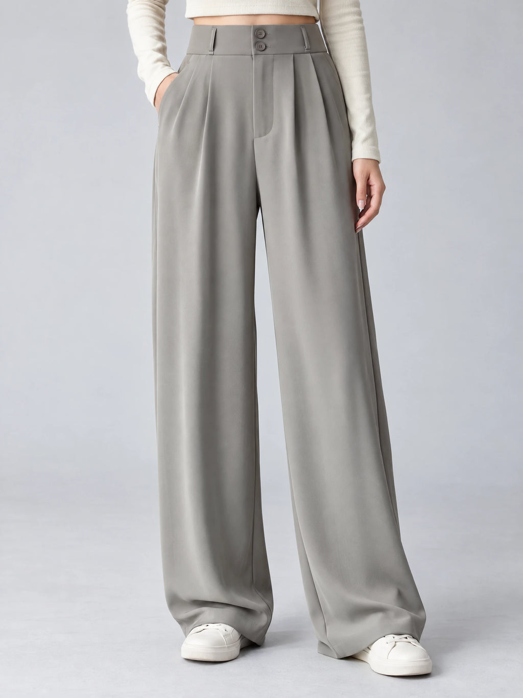 Front studio view of a model wearing Gray high waist wide leg pants with a double-button waistband and side pockets.