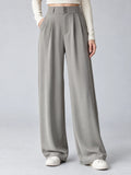 Front studio view of a model wearing Gray high waist wide leg pants with a double-button waistband and side pockets.