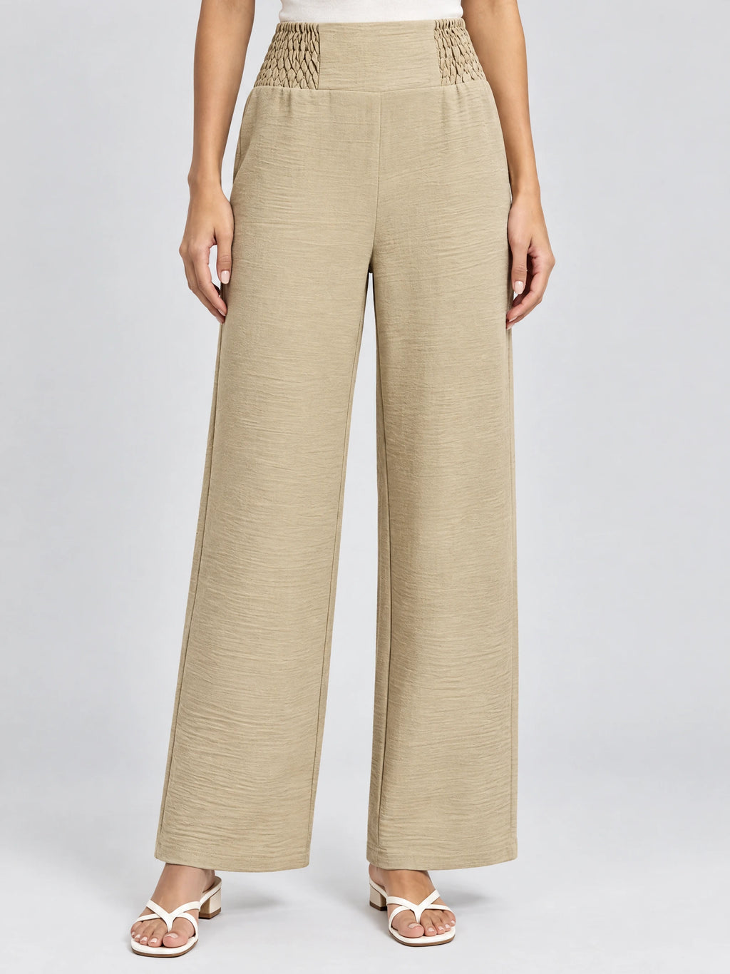 Front studio view of a model wearing Khaki high waist wide leg pants with a textured elastic waistband.