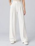 Front studio view of a model wearing White high waist wide leg pants with pleats, front buttons, and side pockets.