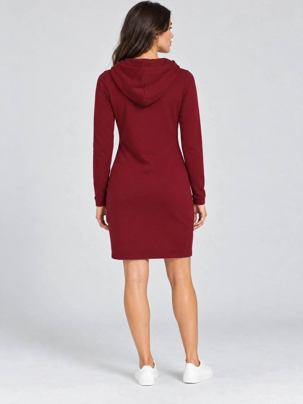 Rear view of a model wearing a Red cotton hooded dress with long sleeves and a knee-length fitted silhouette.