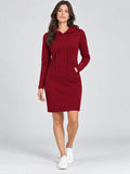 Model wearing a Red cotton hooded dress with drawstrings and a kangaroo pocket in a front studio view.