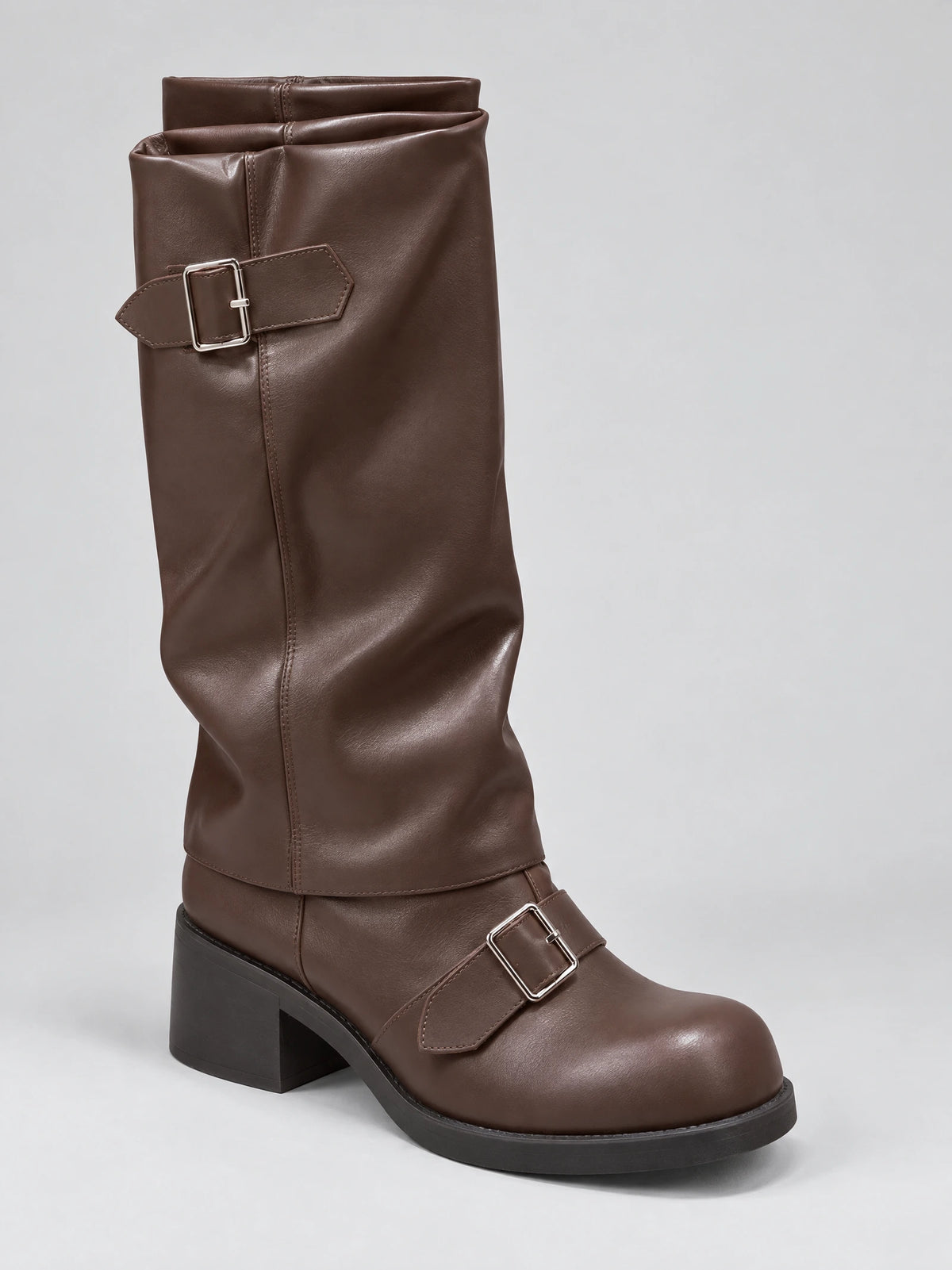 Brown leather knee high chunky boot in three-quarter view with buckle straps, a rounded toe, platform sole, and block heel.