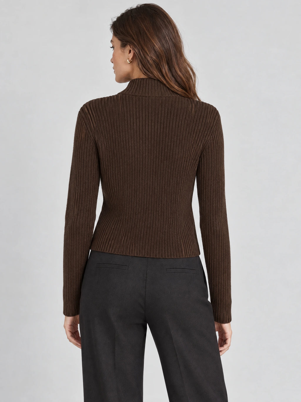 Back view of a model wearing a Brown ribbed knit cardigan with a high collar and long sleeves.
