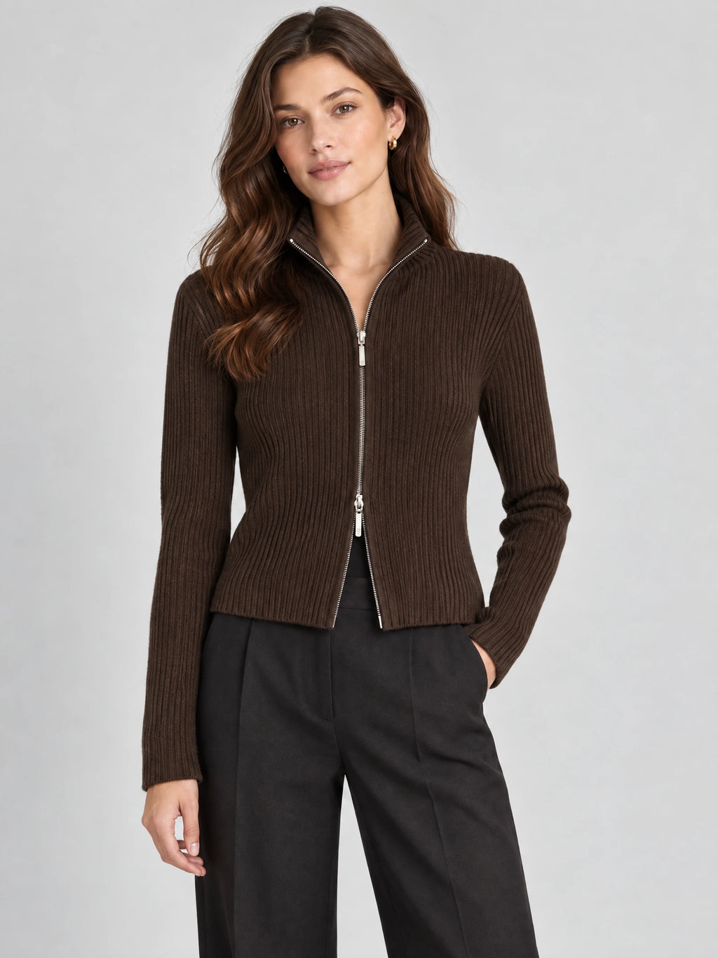 Front studio view of a model wearing a Brown ribbed knit cardigan with a high collar and two-way zip closure.