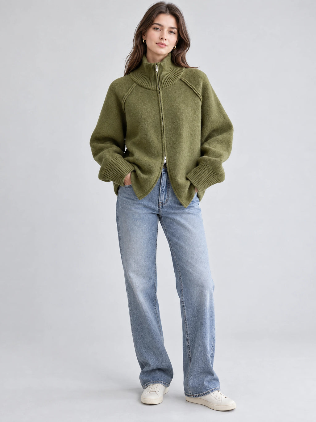 Front studio view of a model wearing a Green knit full zip sweater with a ribbed high collar and cuffs.