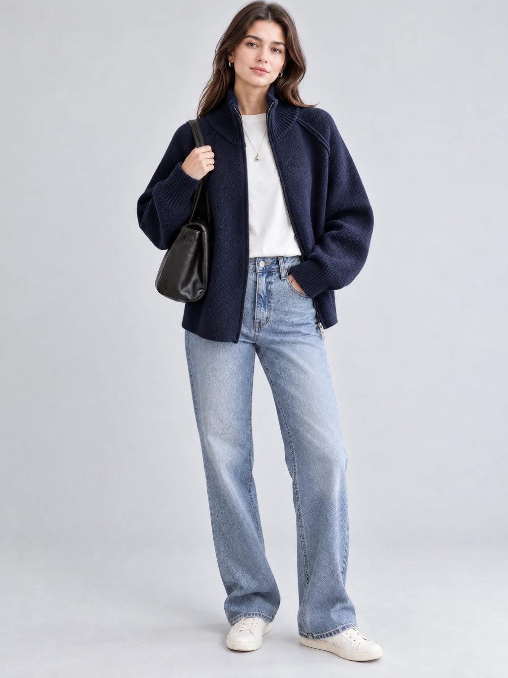 Model wearing a Navy knit full zip sweater with a ribbed stand collar and cuffs in a front studio view.