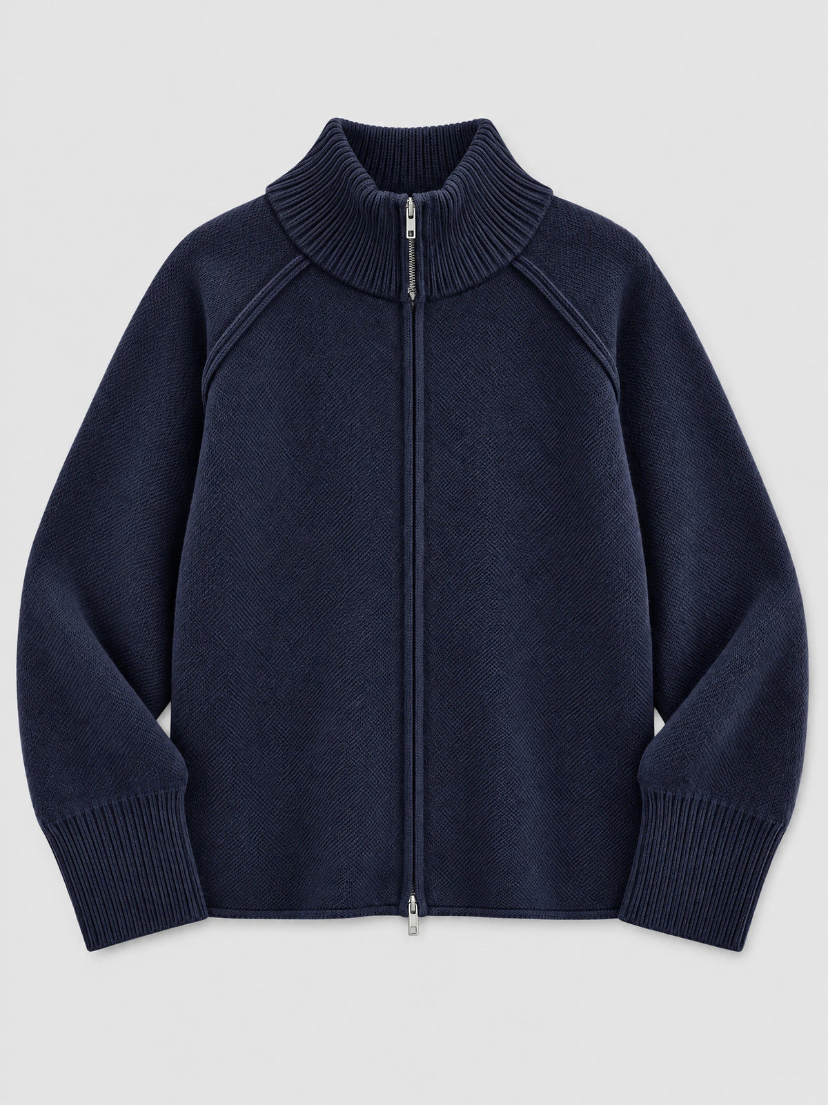 Navy knit full zip sweater laid flat, featuring a ribbed stand collar, ribbed cuffs, and front zipper.