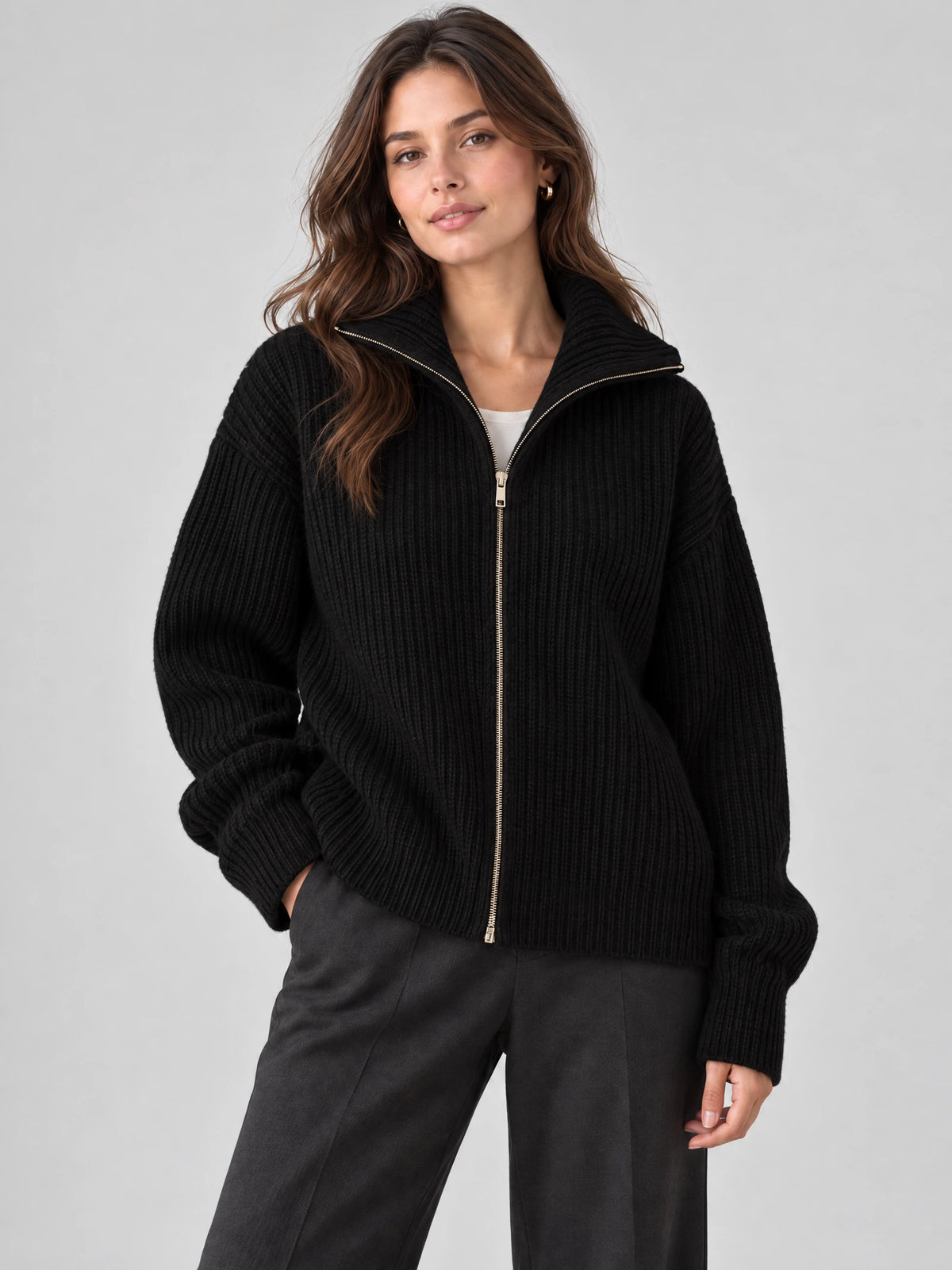 Model wearing a Black ribbed Knit Turtle neck Cardigan with a front zipper in a studio view.