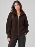 Front studio view of a model wearing a Brown ribbed Knit Turtle neck Cardigan with a full zip and high collar.