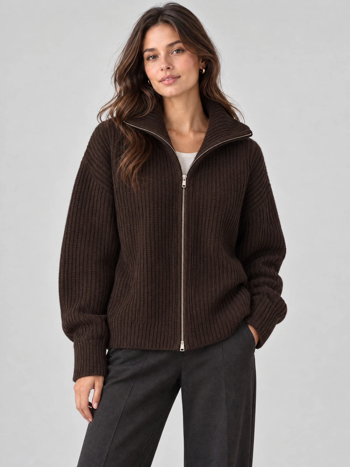 Front studio view of a model wearing a Brown ribbed Knit Turtle neck Cardigan with a full zip and high collar.