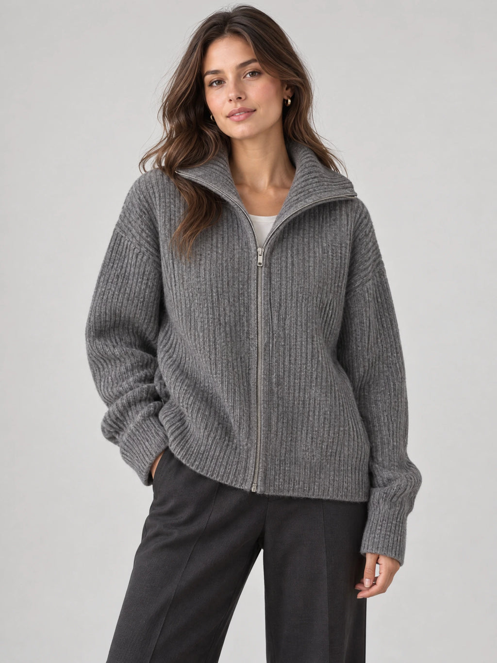 Front studio view of a model wearing a Gray ribbed knit turtle neck cardigan with a full zip and relaxed sleeves.