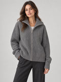 Front studio view of a model wearing a Gray ribbed knit turtle neck cardigan with a full zip and relaxed sleeves.