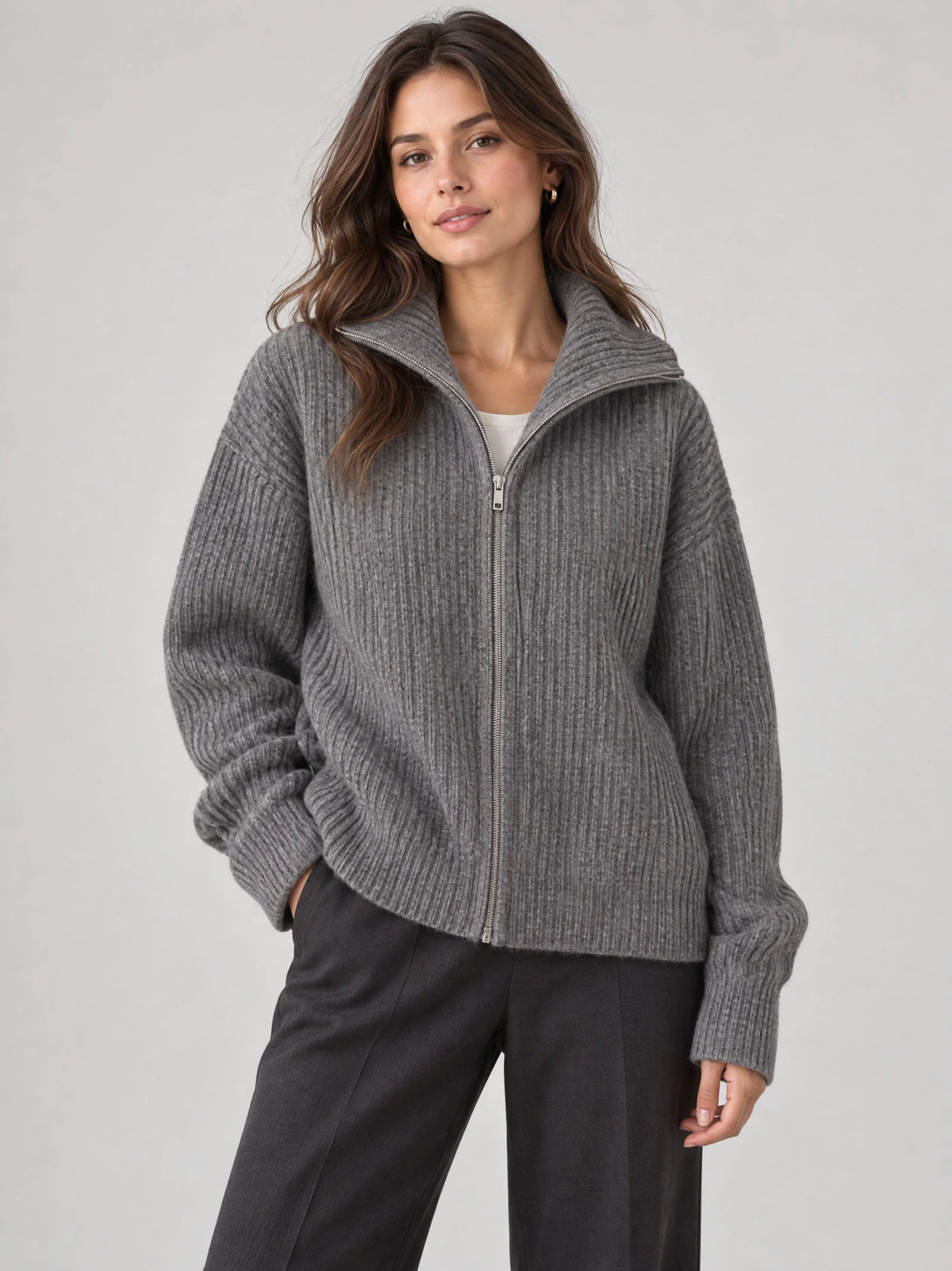 Front studio view of a model wearing a Gray ribbed knit turtle neck cardigan with a full zip and relaxed sleeves.