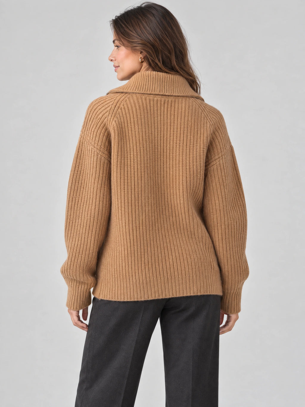 Back view of a model wearing a Khaki ribbed knit turtleneck cardigan with a wide folded collar.