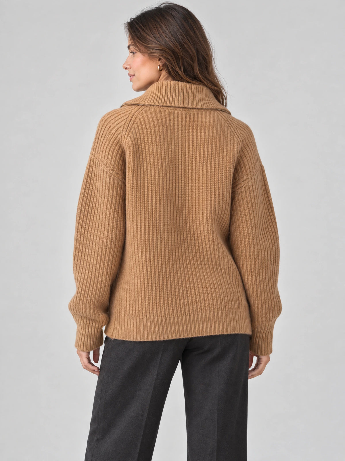 Back view of a model wearing a Khaki ribbed knit turtleneck cardigan with a wide folded collar.