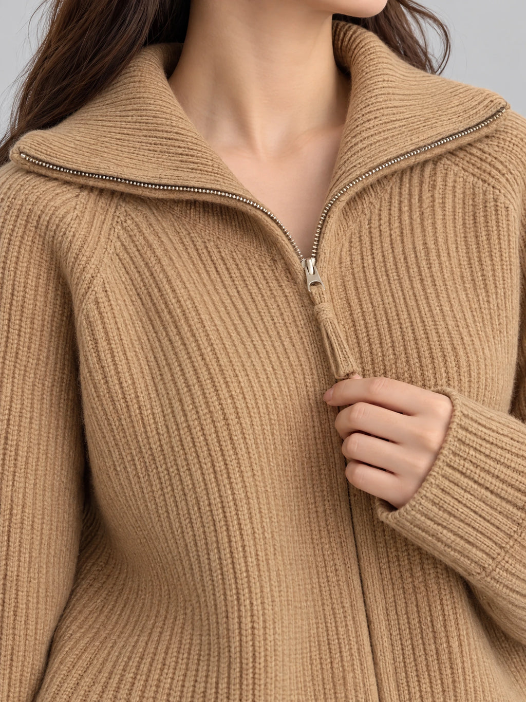 Close-up of the Khaki Knit Turtle neck Cardigan showing ribbed knit texture, a folded high collar, and half-zip closure with a knit pull.
