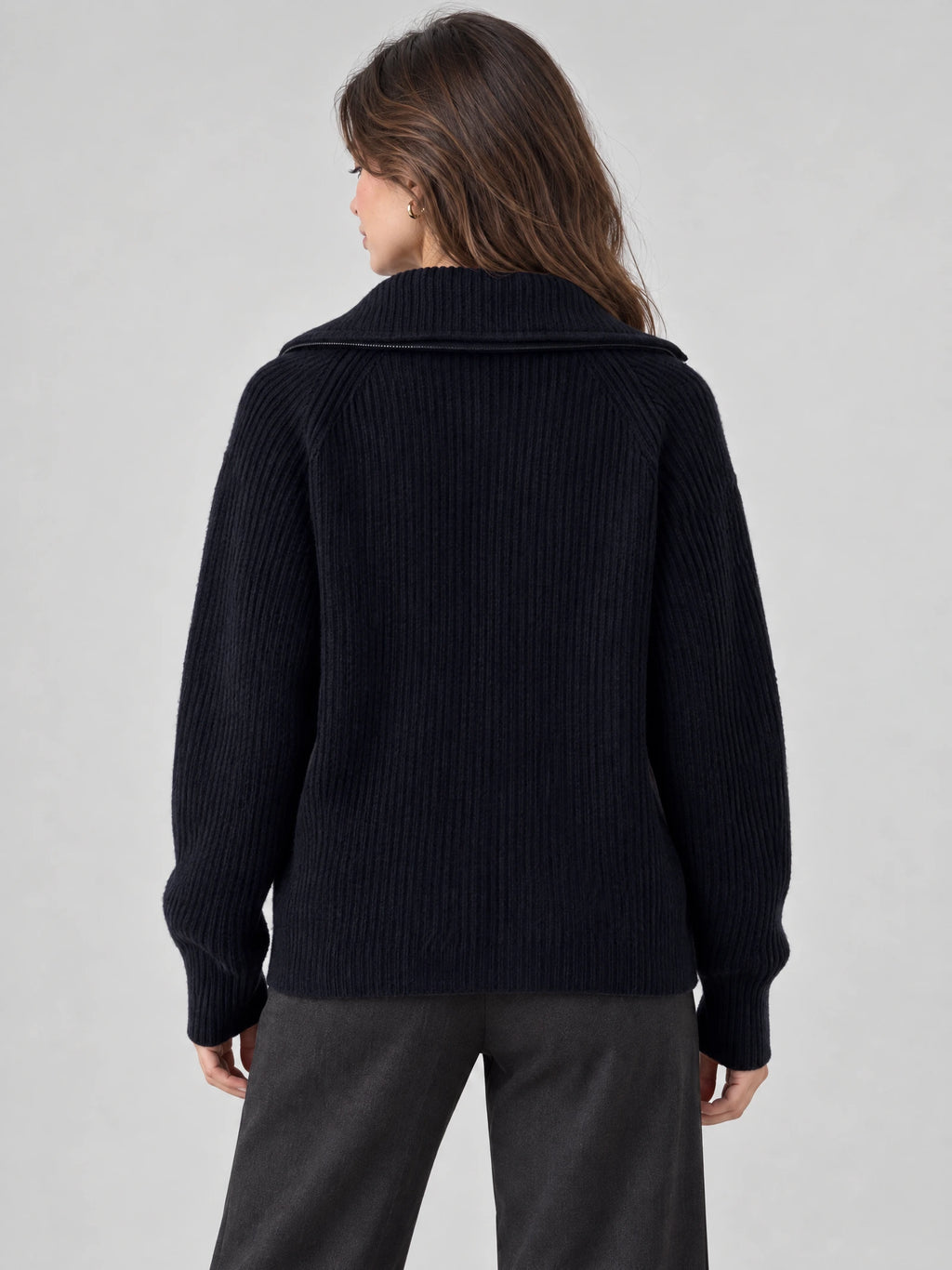 Rear view of a model wearing a Navy ribbed knit turtleneck cardigan with a wide folded collar and long sleeves.