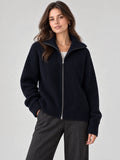 Front studio view of a model wearing a Navy ribbed Knit Turtle neck Cardigan with a full zip and high collar.