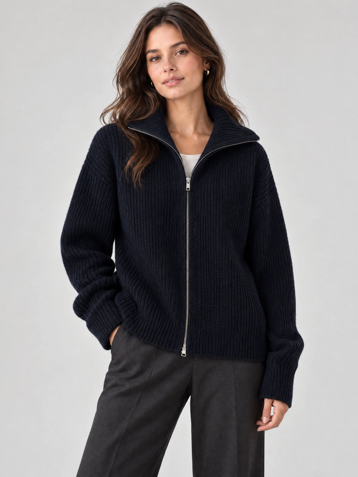 Front studio view of a model wearing a Navy ribbed Knit Turtle neck Cardigan with a full zip and high collar.