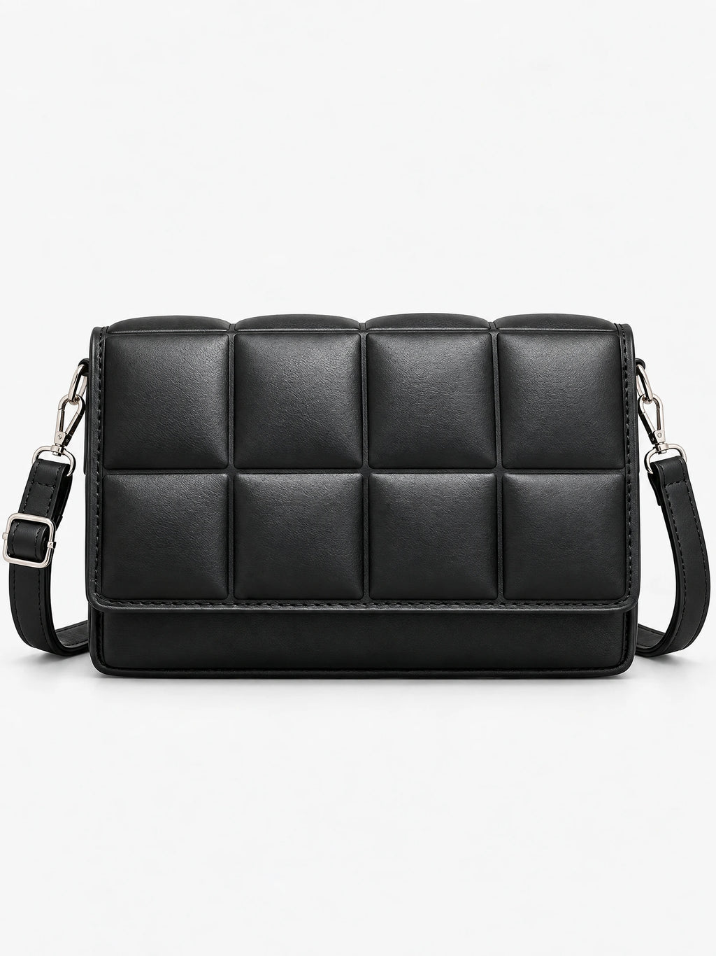 Black leather cross body bag shown from the front in a studio, with a padded grid panel and adjustable strap.