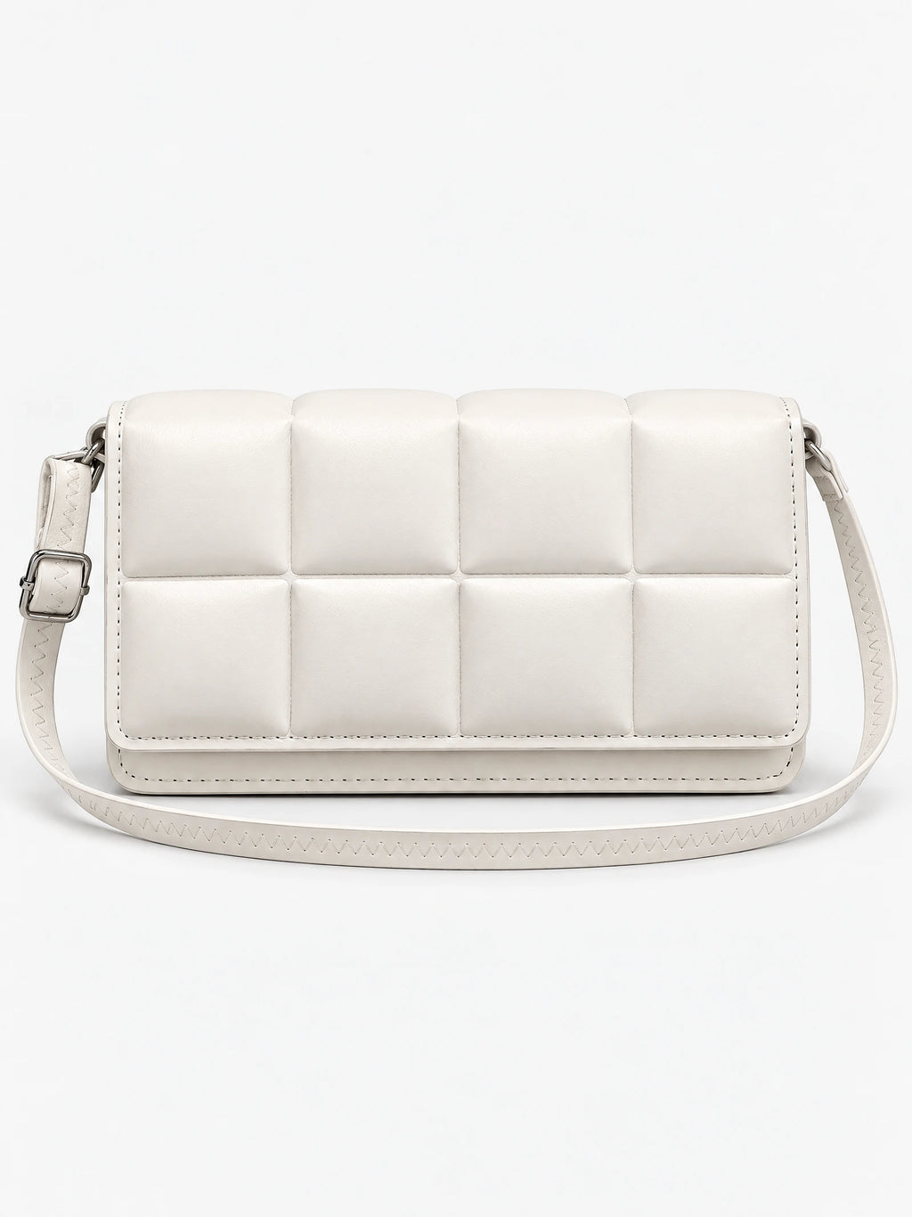 White leather cross body bag shown front-on with a padded grid panel and adjustable shoulder strap.