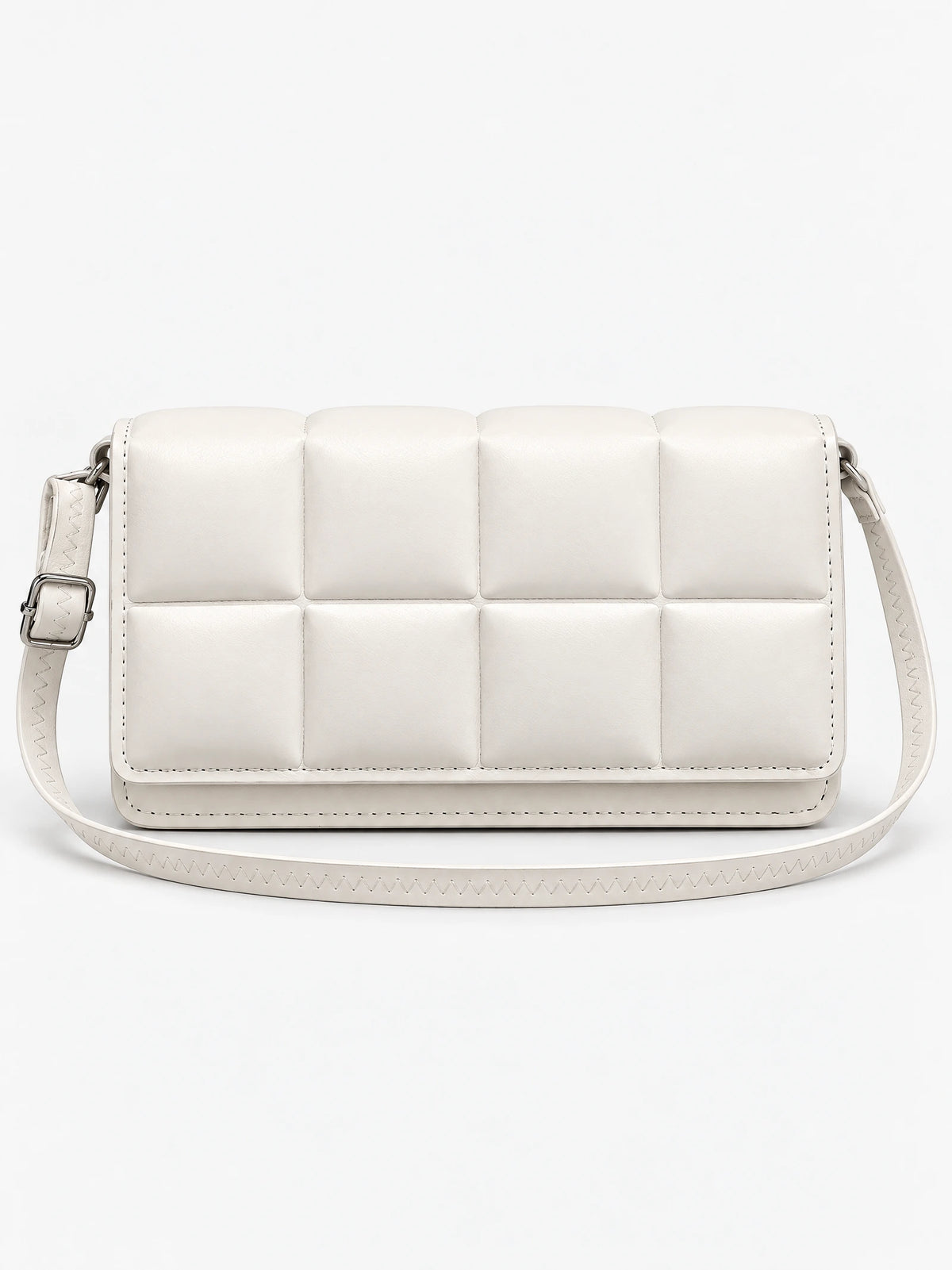 White leather cross body bag shown front-on with a padded grid panel and adjustable shoulder strap.