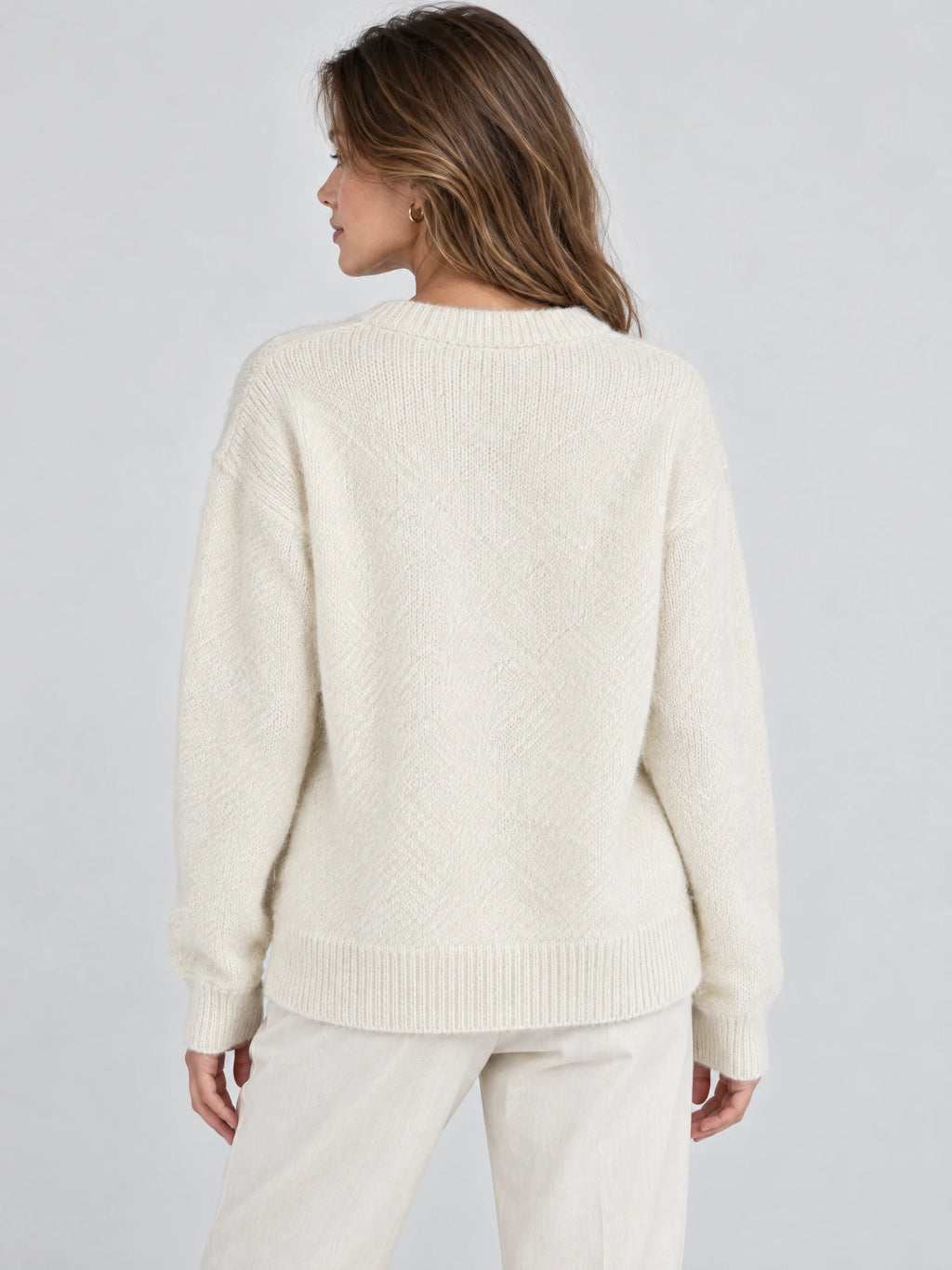 Back view of a Beige women’s mohair winter sweater with a ribbed crew neckline, cuffs, and hem.