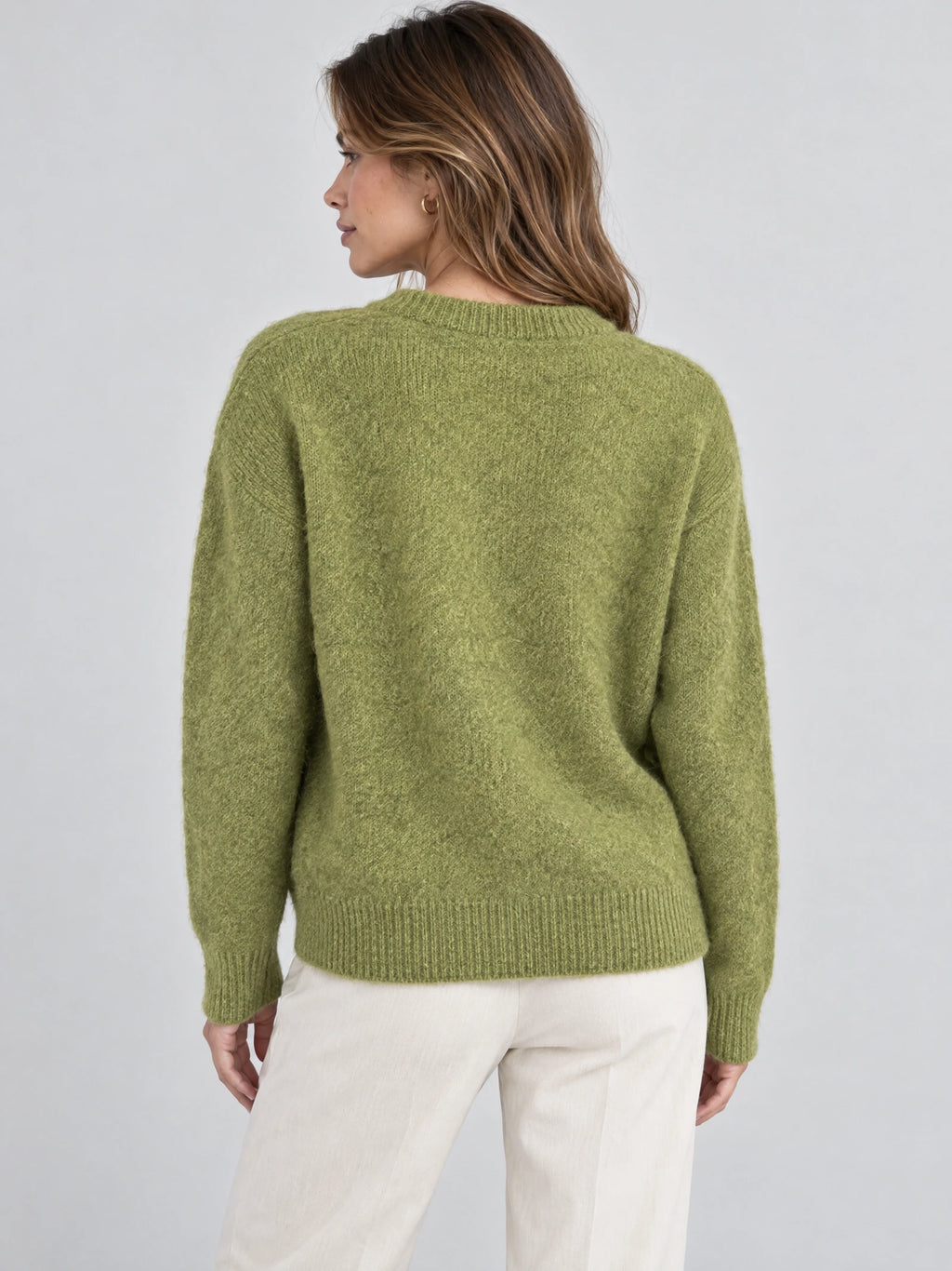 Back view of a model wearing a Green Women Mohair Winter Sweater with a ribbed crew neckline, cuffs, and hem.