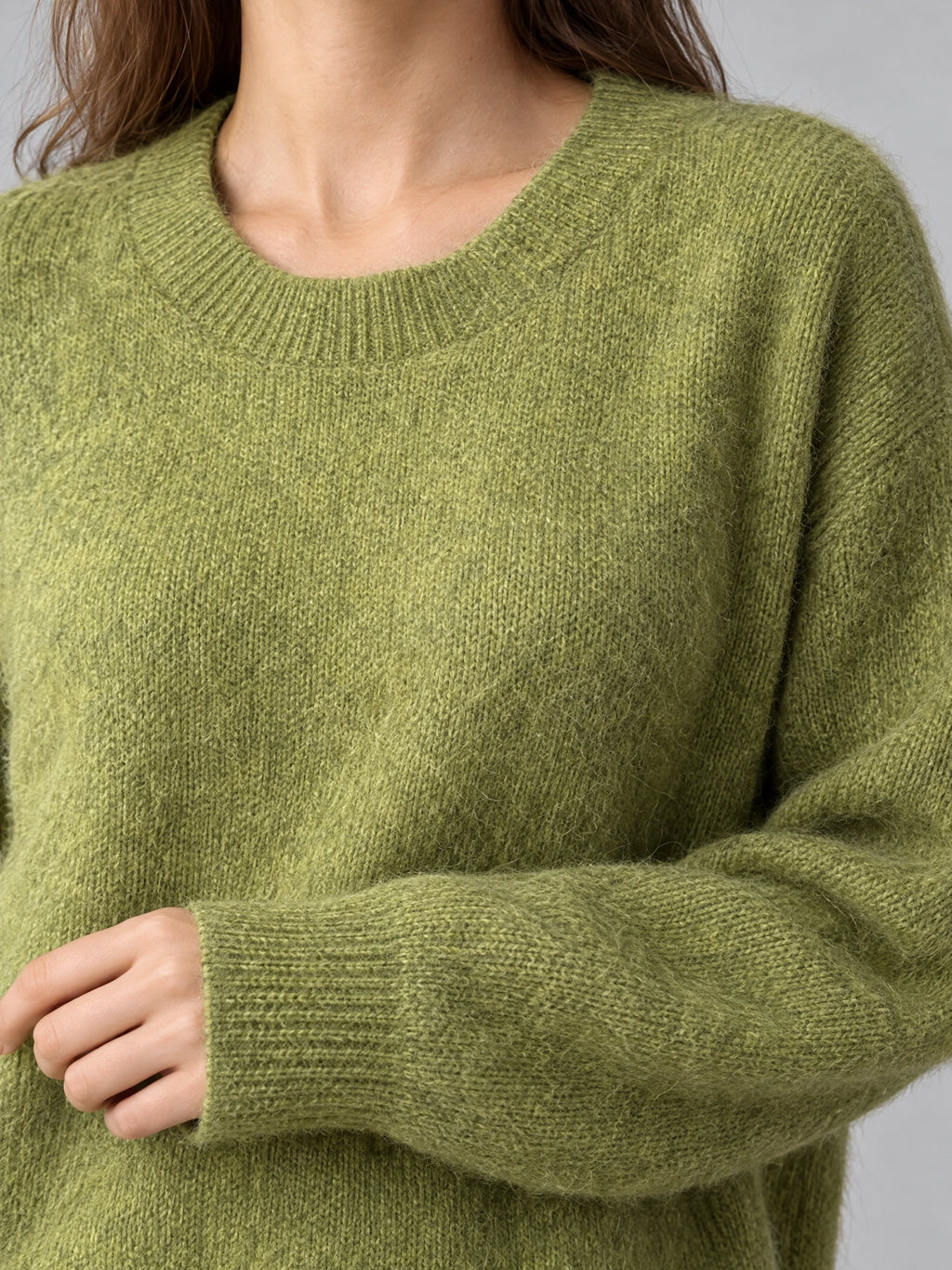Close-up of the Green Women Mohair Winter Sweater showing its fuzzy knit texture, ribbed crew neckline, and cuff.