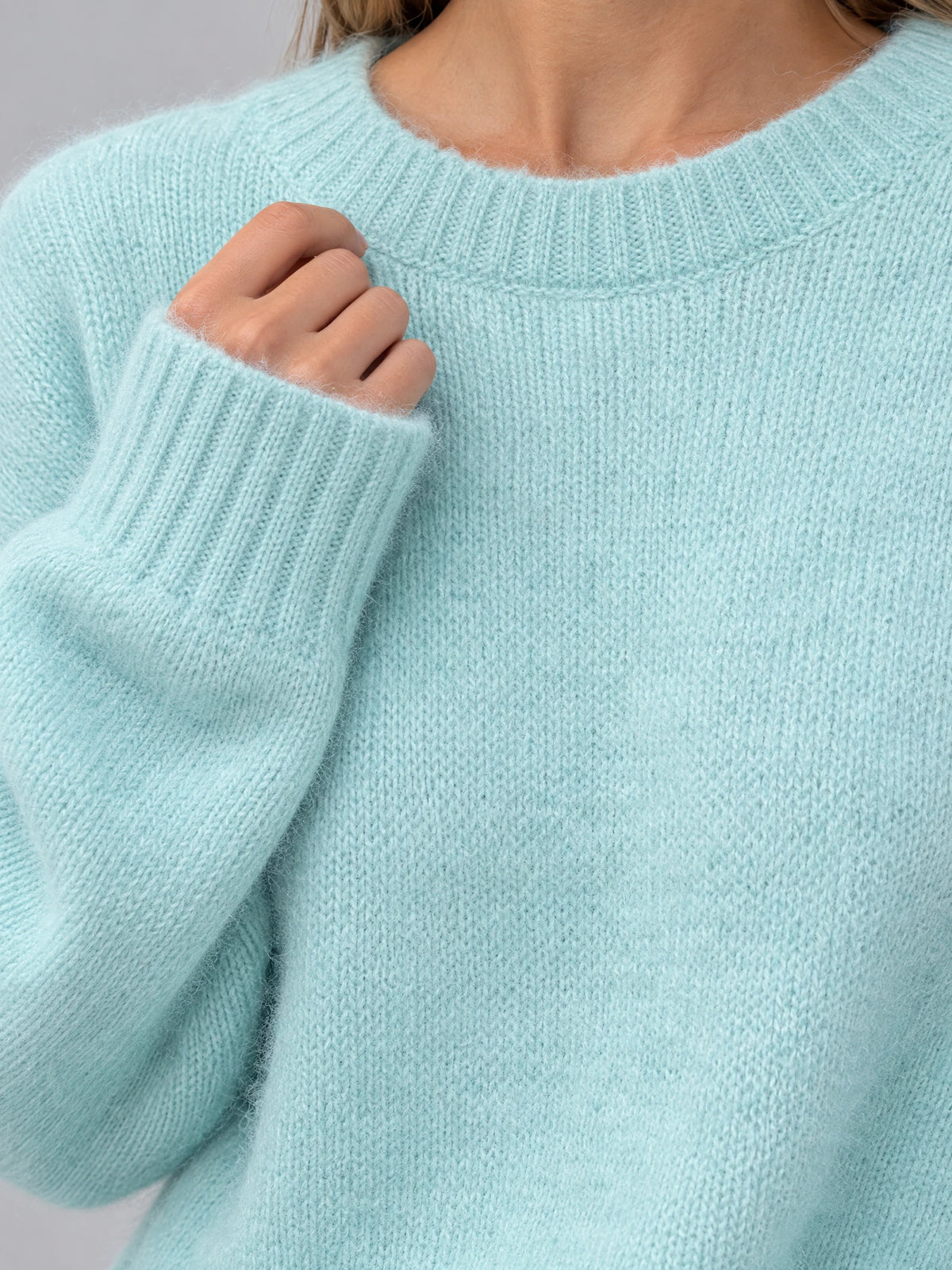 Close-up of the Light Blue Women Mohair Winter Sweater showing its fuzzy knit texture, ribbed crew neckline, and cuff.