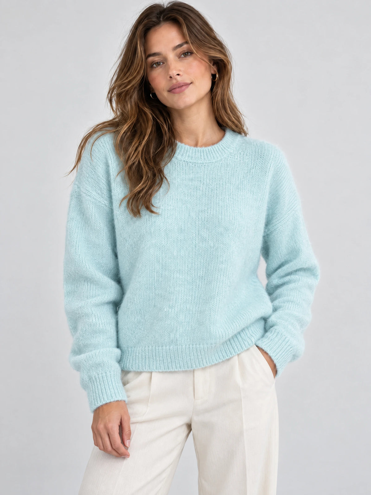 Front studio view of a model wearing a Light Blue Women Mohair Winter Sweater with a ribbed crew neckline, cuffs, and hem.